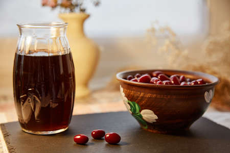 Natural healthy calming drink with dogwood berry. Autumn healthy food. Pastel colors with copy space. Healthy organic food. Vitamin tea. Home coziness, decorations table. High quality photoの写真素材