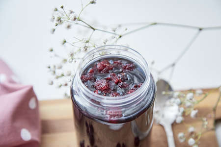 Healthy fermented honey product with cranberry. Food preservative at home, cozy, rustic flat lay....