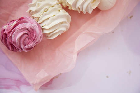 Healthy natural delicate pink and white marshmallow close up. Winter aesthetic. Top view. Cozy...