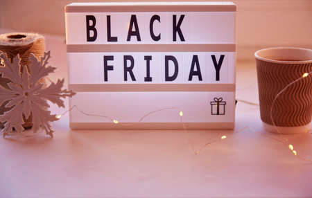 Signboard with text Black Friday, cardboard cup with cocoa. Online shopping concept. Buying presents for Christmas. Top view. High quality photoの写真素材