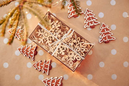 Festive card with gift box, crafting decoration, Christmas cookies of Christmas tree on basic dot...