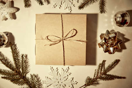 Festive vintage retro card with present box, crafting decoration, branch of fir tree and shadows....
