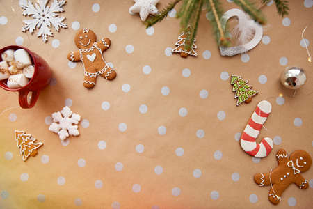Child with Christmas homemade cookies, hot beverage with marshmallow, festive Christmas decorations. Aesthetic Christmas atmosphere, home coziness and warmth concept. Festive Christmas tsble settingの写真素材