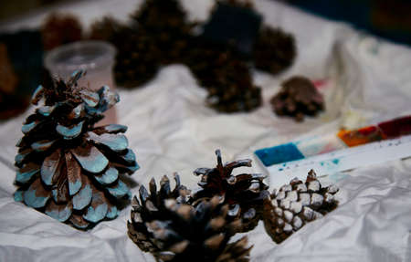 Coloring New Year's holiday cones by a child. Teaching children, developing motor skills. Global crafting hobby. Preparing for Christmas. Natural ornaments. High quality photoの写真素材