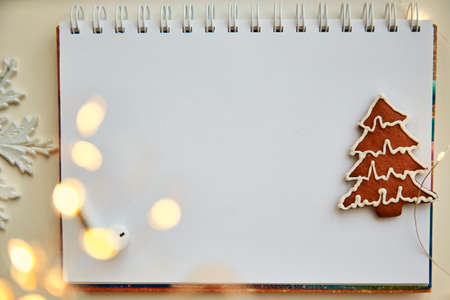 Mockup of notebook with New Year's decorations. The concept of New Year's decisions and resolutions...