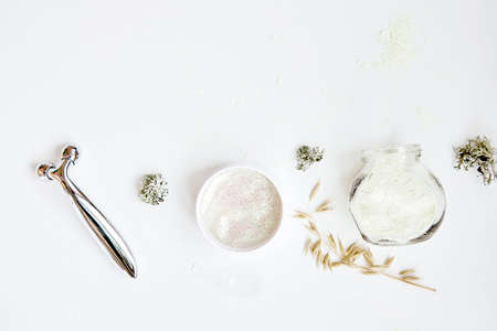 Wellness face care cosmetics set. Massager, alginate mask and patches. Dermatology multiuse cosmetics, multitasking beauty. Scinimalism concept, polytasking functions. Natural eco forest moss and oatの写真素材