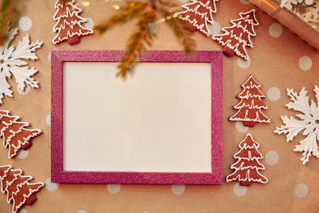 Christmas homemade gingerbread cookies with pink mock up frame. Homemade baked cookies. Festive aesthetic card. Christmas atmosphere. Merry Christmas and home coziness concept. High quality photoの写真素材