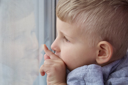 Cute toddler point to a window and looking close up. Hope, watching and waiting concept. Copy space. High quality photoの写真素材