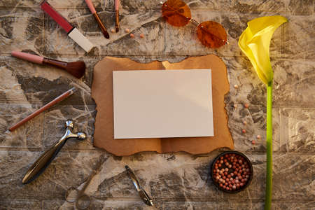 Beauty products with vintage mock up paper. Face care products for make up: massager, makeup...