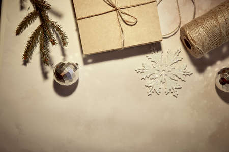 DIY handmade Christmas present. Retro vintage card with crafting decoration, string, branches of fir...