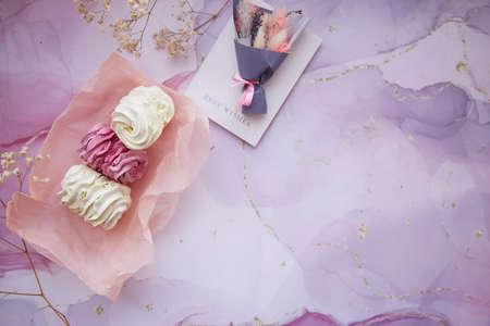 Delicate pink and white marshmallow with decoration of gypsophila and dryflowers bouquet. Cozy...