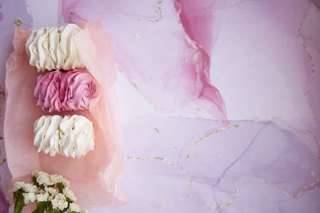 Tender pink and white marshmallow with decoration of dryflowers. Feminine card concept. Cozy winter weekends. Homemade sweets. Top view. High quality photoの写真素材