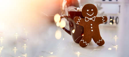 Symbol of Christmas - homemade gingerbread cookie and blurred bokeh decor. Festive Christmas...
