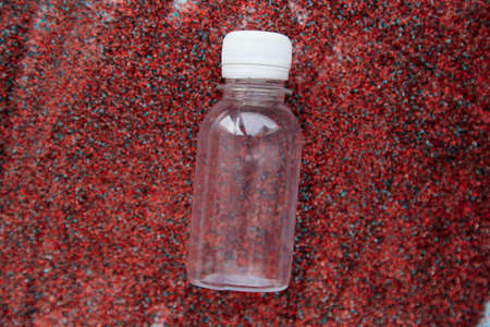 Mock up transparent container for cosmetic product,gel or shampoo on bright sand background. Creative mockup of beauty product. Wellness concept.の写真素材