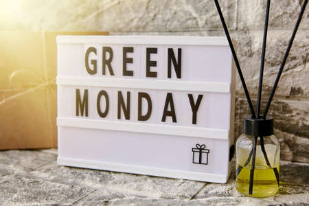 Lightbox Green Monday text, crafting gift box and aroma diffuser. Concept of online shopping from home. Cozy home atmosphereの写真素材