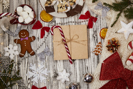 Christmas food and decoration: stollen, chocolate, gingerbread cookies, hot beverage with caramel...