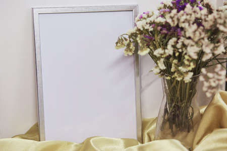 Minimalist mockup wall frame and vase with dried flowers. Place for text or advertisingの写真素材