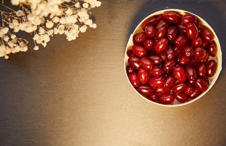 Natural healthy dogwood berry in the clay bowl. Autumn healthy food for vitamin compote or tea....