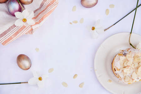 Easter elegant background. Purple vintage and orange multicolored eggs, narcissus flowers and almond...