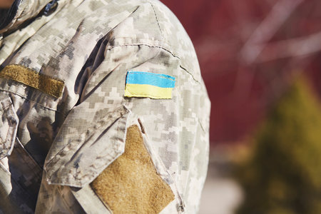 Ukrainian flag on uniform of soldier close up. Stop russian aggression. Stop war in Ukraine. Stay with Ukraine. breaking news. Pray for Ukraine. copyspace.の写真素材
