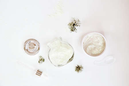 Natural wellness face care cosmetics set on white gradient background. Alginate mask and transparent...