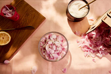Aesthetic homemade organic rustic jam preparing with sugar, lemon and tea rose petals. natural...