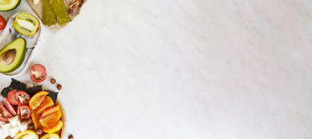 Salad with tomatoes, basil, feta cheese, sesame. Superfood snacks - spirulina, flax seeds, ginger, wasabi. Natural, organic food. Kiwi, avocado, nuts. Proper nutrition. Extra wide banner. copyspace.の写真素材