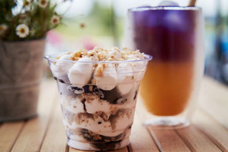 Organic natural soft drink with blueberries, seeds, basil extract, leaves, ice. Refreshing summer Asian drink.の写真素材
