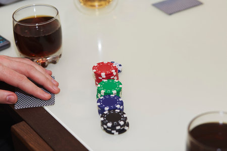 Concept of playing poker on the table with chips and cards. A glass of whiskey. Gambling concept....