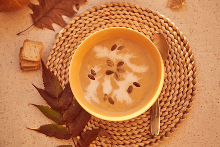 Traditional seasonal healthy vegetarian pumpkin cream soup with seeds and plant-based creamの写真素材