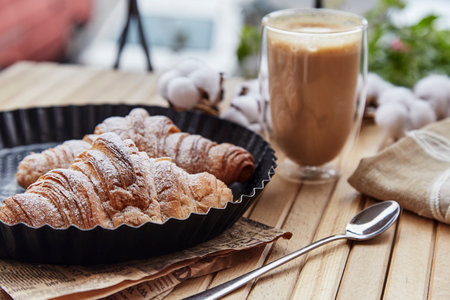 French breakfast - croissants with glass of latte outside.Aesthetic morning.の写真素材