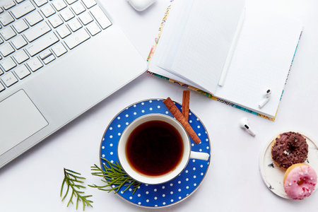 Lifestyle mockup notepad with aesthetics coffee cup, doughnut, earphones among Christmas decorations. New year resolution, planning, new start and list of goals concept.の写真素材