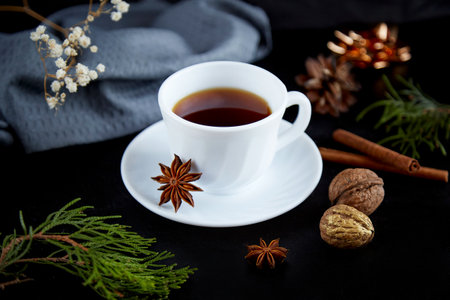 Aesthetics coffee cup with marshmallows, walnuts and spices among Christmas bokehの写真素材