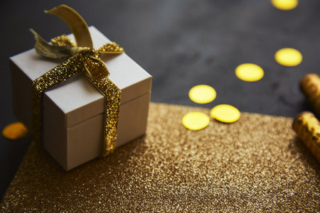 Christmas gift black and golden background among decorations and bright glitter. Copy space.の写真素材