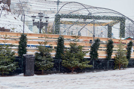 Christmas tree market. Snowy fir trees outside on the square.Festive background at snowy day. Merry Christmas and happy holidays.の写真素材