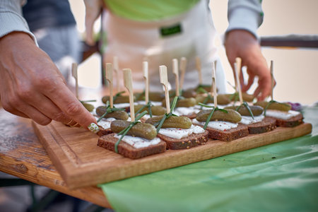 Serving of traditional Ukrainian sandwiches with pork lard and pickles. Catering, banquet concept.の写真素材