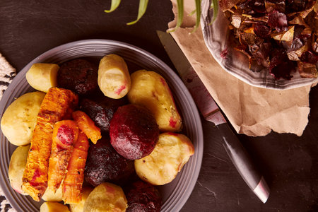 Peeled baked vegetables - baked potatoes, carrots, beetroot on rustic background. Whole food diet, Mediterranean dietの写真素材