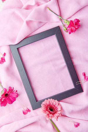 Aesthetic empty floral flat lay frame among gerberes, asters flowers with copy space. Concept of...