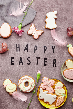 Easter glazing cookies, feathers, aster flowers flat. lay Happy Easter text. Spring stylish background.の写真素材