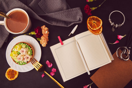 Aesthetic floral french tart among flowers, coffee cup, mock up of notepad, accessories flat lay. Desserts using the trend Dreamy Escapism. Pink floral cake.の写真素材