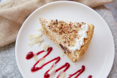 Honeydew cake with prunes and nuts on the plate top view. Sugar free, gluten free, vegan piece of...