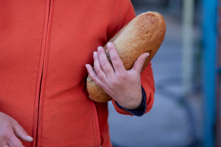 Close up of woman holding loaf of white bread.の写真素材