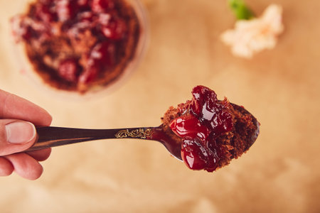 Eating of layered dessert with fresh cherry. Vegan natural lactose free, sugar free french food. Dessert using the trend Dreamy Escapism.の写真素材