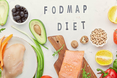Low fodmap ingredients diet - seafish, vegetables and fruits, nuts, greens, beans. Fodmap diet concept with text in center. flat lay.の写真素材