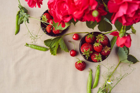 Natural summer background with roses and food. Cherry, strawberry, peas. copyspace. Rural, sustainable life concept. enjoy the little things.の写真素材