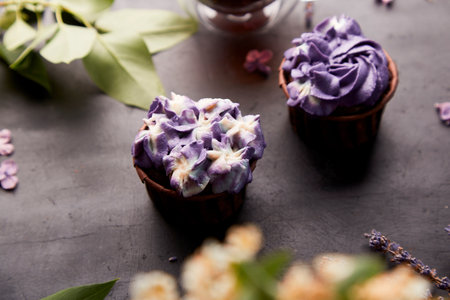Aesthetics close up purple floral cupcakes using trend Dreamy Escapism. Desserts and flowers background.の写真素材