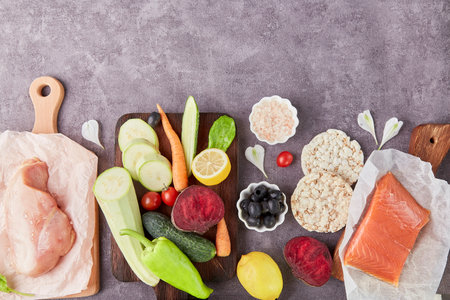 Aesthetics vegetables, chicken fillet, olives, salmon and greens top view. Keto, Paleo, Low carb, FODMAP diet concept.の写真素材