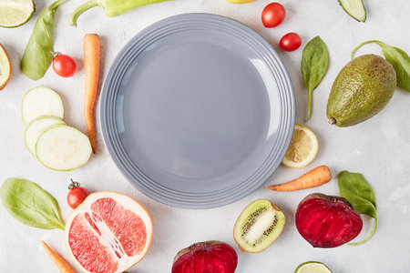 Aesthetics food, Plant-based, Keto, FODMAP, Paleo, Low-carb diet concept. Gray plate in the center among vegetables and fruits.の写真素材