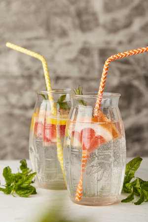 Refreshing cocktails with citrus fruits. Vitaminized summer detox water. Low-alcohol drinks without...