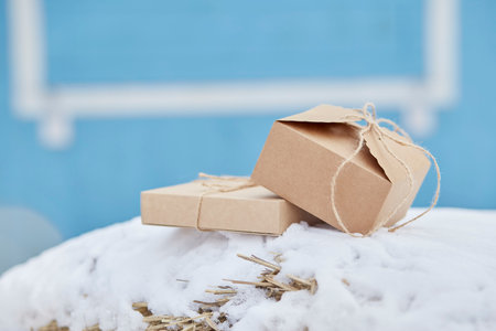 Paper crafting Christmas presents outside on the snow. Happy holidays.の写真素材